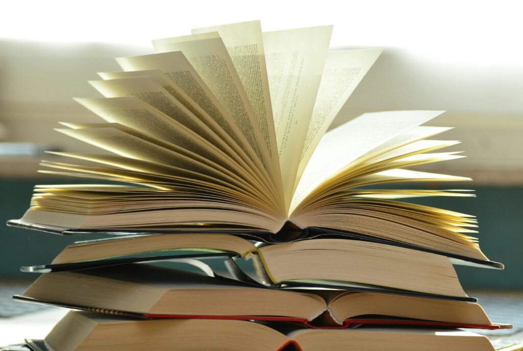 books-book-pages-read-literature-159866-159866 A close-up of a stack of open books with pages fanned out, capturing a study atmosphere.